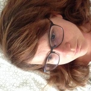 the author,Sandra, thinking not looking into camera